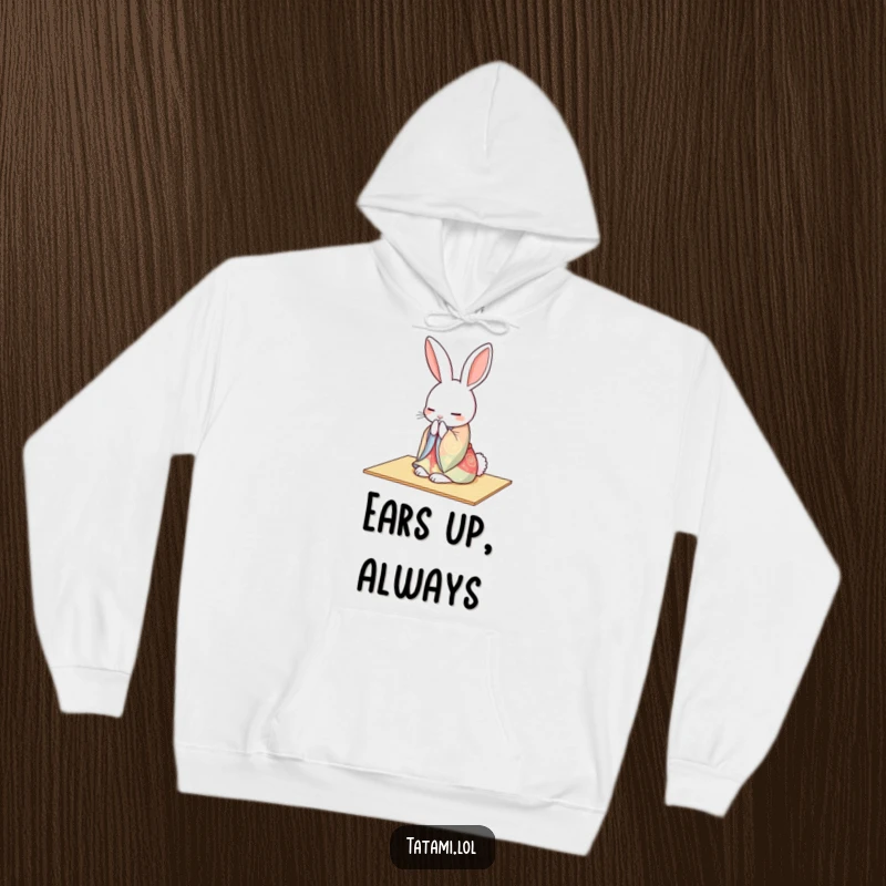 A peaceful rabbit in a colorful kimono gracefully bowing on a tatami mat, featured on a cozy hoodie.