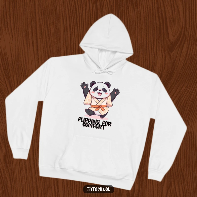Funny hoodie featuring a joyful panda in a patterned kimono, performing a gentle somersault, providing cozy humor.
